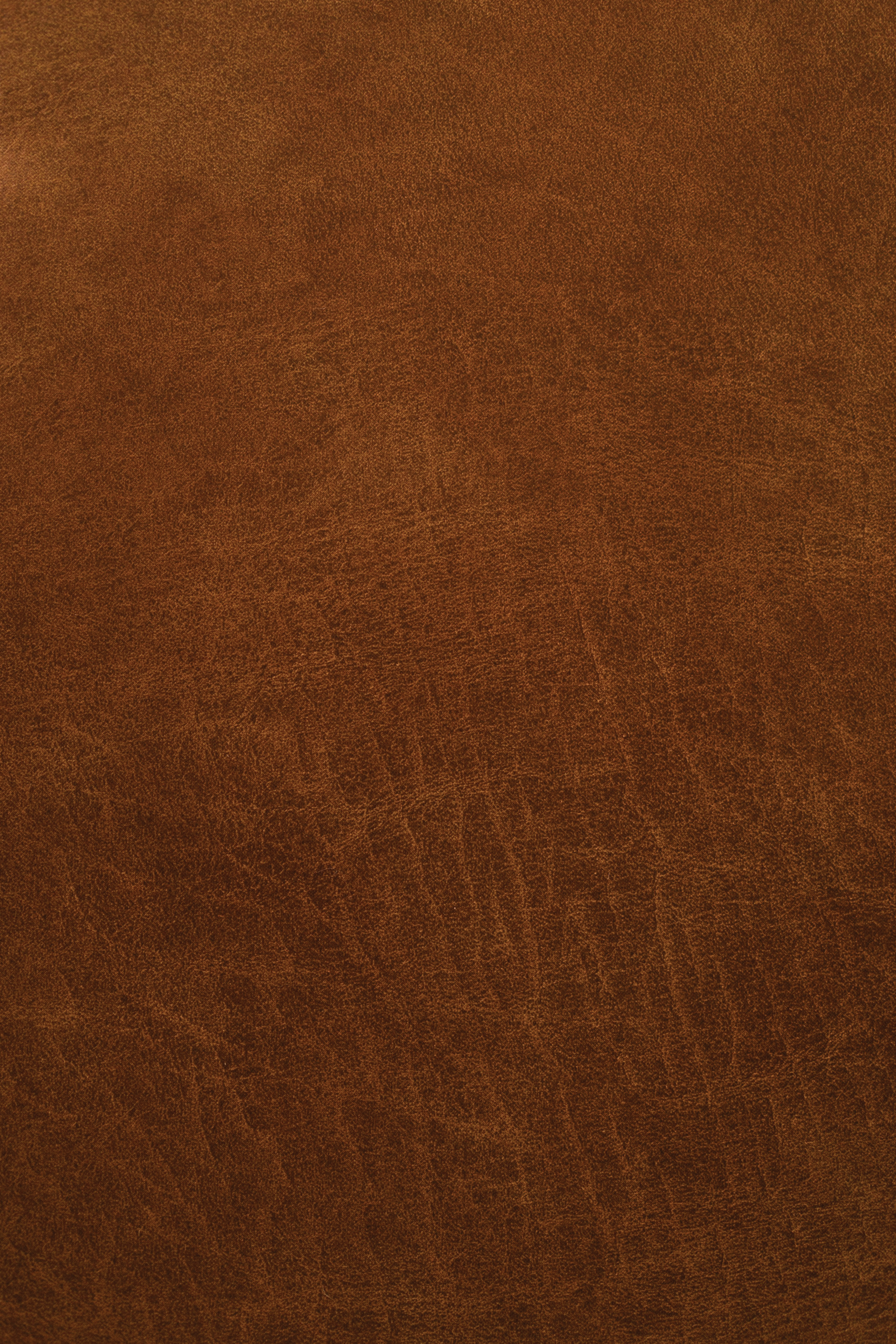 Close-up of a warm brown mango-based leather surface